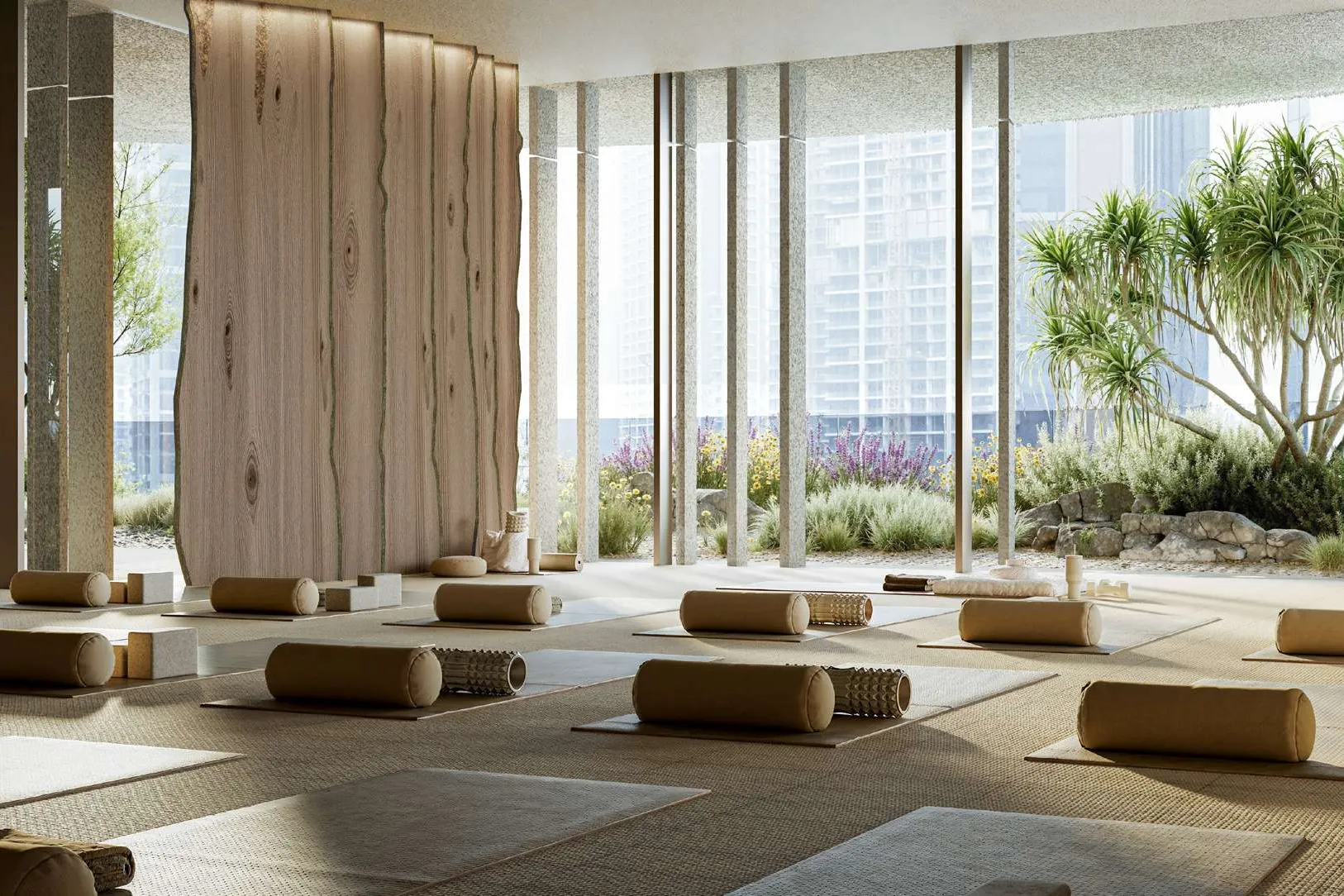 Airy yoga studio with timber wall, mats and garden views
