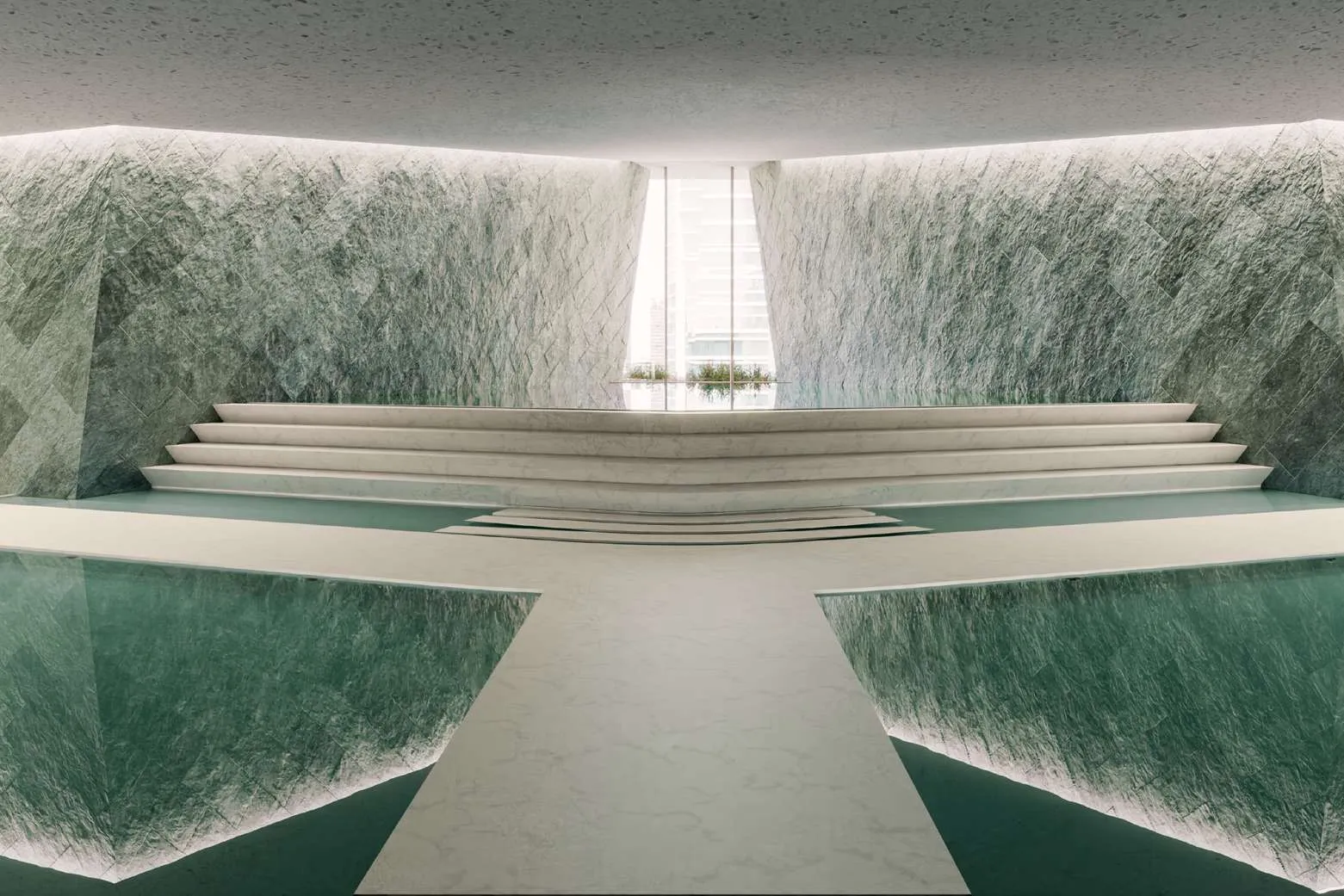Indoor lagoon framed by green stone walls and stepped marble